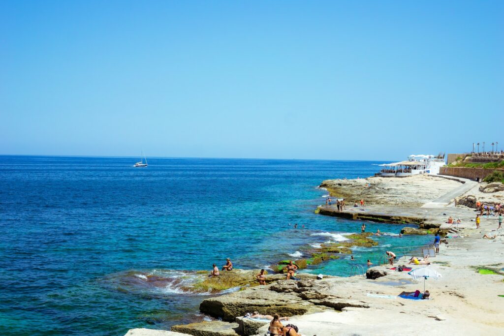 a beach with people and boats